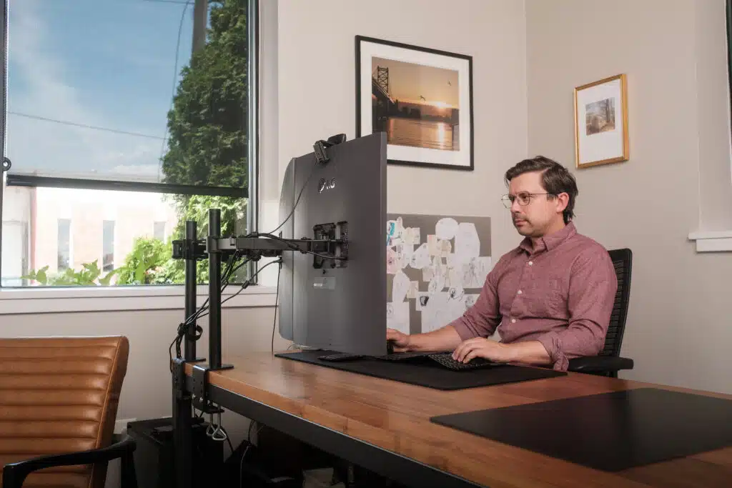 Photo of SIWSCO CEO Paul Pallas working at his computer